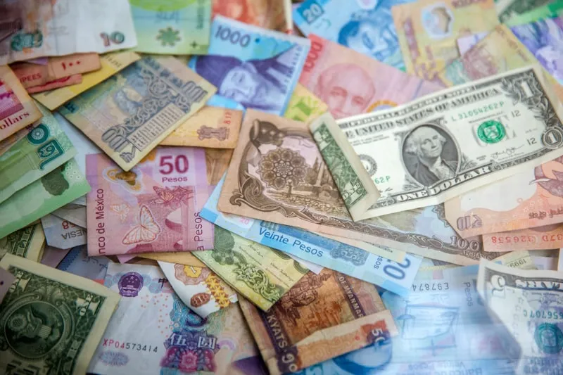 A spread of banknotes from many different countries.
