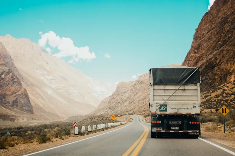 A delivery truck driving a mountain highway.